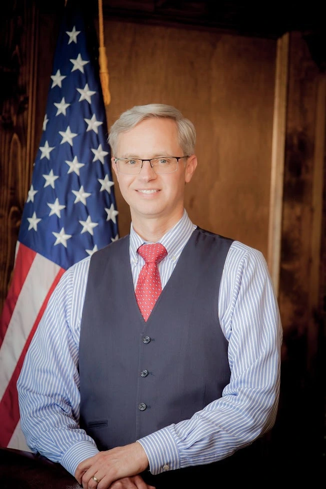 Portrait of Clardy by the American Flag